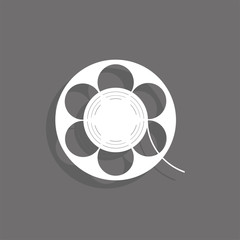 Coil with a film. White vector icon on a gray background with a shadow.