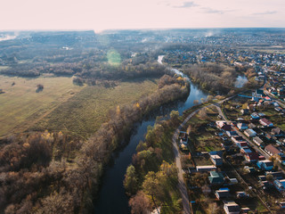 Golden red sunlight AERIAL view, Russia, River, small town, bridge