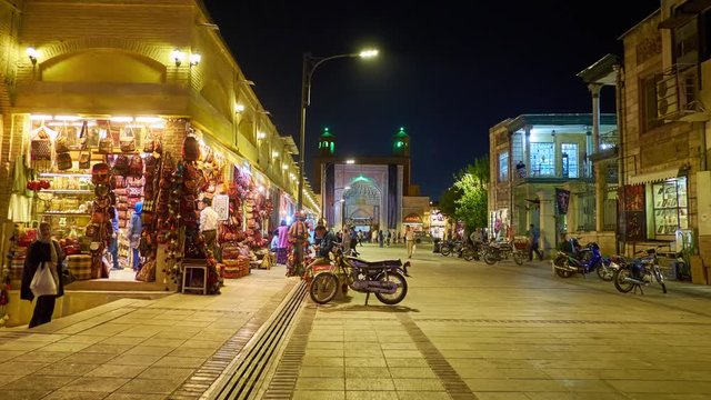 The evening in Vakil Bazaar, multiple shops are full of handicrafts and souvenirs, Vakil Mosque's iwan (portal) is seen on the background,  Shiraz