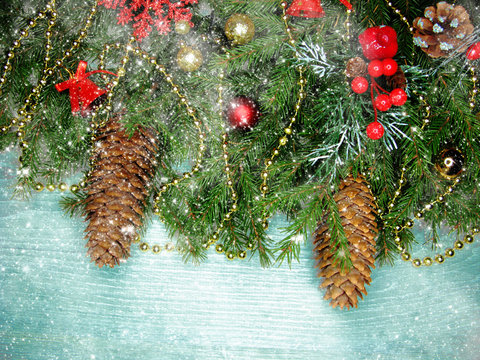 christmas decoration cones and garland lights on wooden background