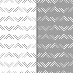 Set of geometric ornaments. Gray and white seamless patterns