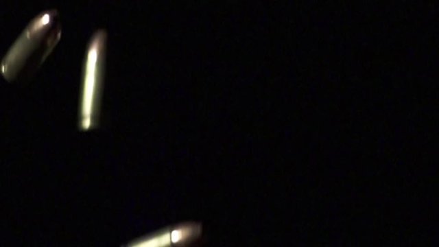 Bullets falling in slow motion on black background