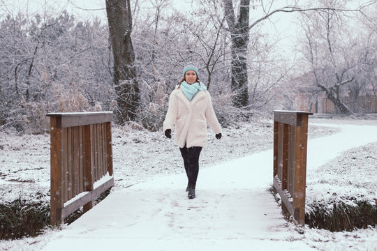 Smiling young woman in snowing outdoor.