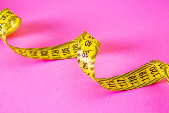 tape measure on pink background
