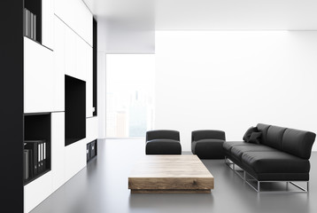 White living room with a black sofa