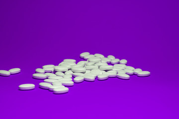 Tablets with calcium on a violet background. White pills on a colored background.