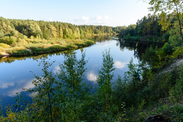 Fototapeta na wymiar high water level in river Gauja, near Valmiera city in Latvia. summer trees surrounding
