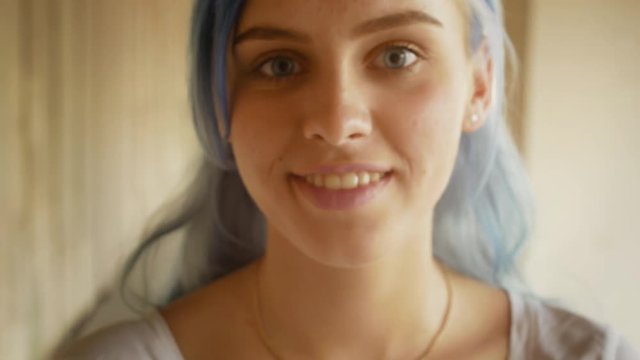 Portrait young blue hair girl smiling summer street close-up