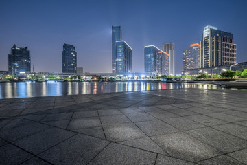 night view of empty brick floor front of modern building