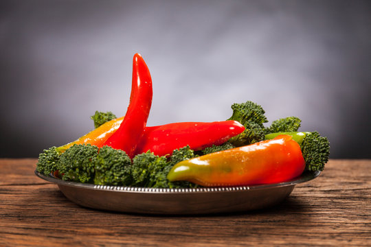 Sexy food: red hot pepperoni with broccoli. Mischievous affinity with penis