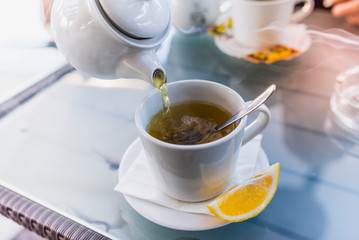 pouring tea into a cup 