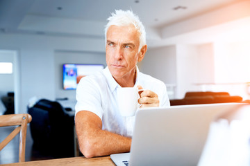 Fototapeta premium Man working on laptop at home