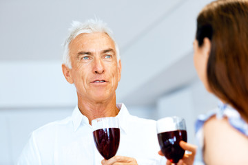 Portrait of a couple having a glass of red wine