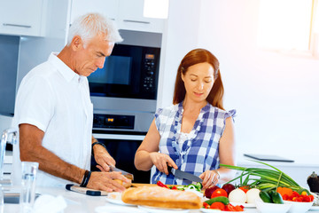 Happy couple cooking at home