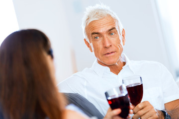 Portrait of a couple having a glass of red wine