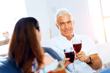 Portrait of a couple having a glass of red wine