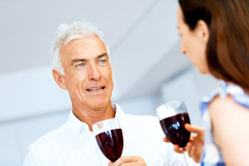Portrait of a couple having a glass of red wine