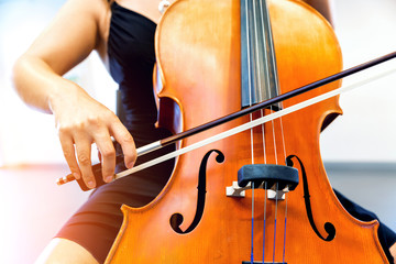 Close up of cello with bow in hands