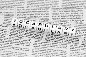 Vocabulary alphabet cubes on newspaper