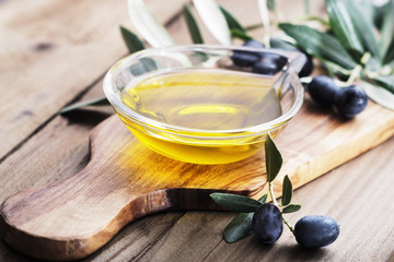 olive oil on rustik wooden background.