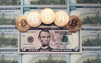 Coins bitcoin, there are money, on the table a 5 dollar bill. The banknotes are spread out on the table in a free order of $ 5. Gold coins are crypto currency.