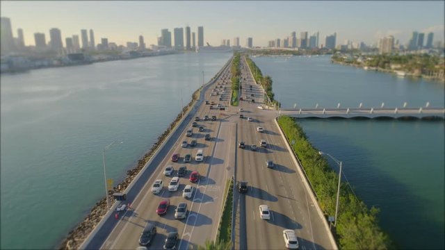 Aerial video Macarthur Causeway pan to reveal palm island tilt shift to blur cruise ship logos