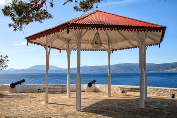 Wooden gazebo near canons at Hydra Island Saronikos gulf in Greece