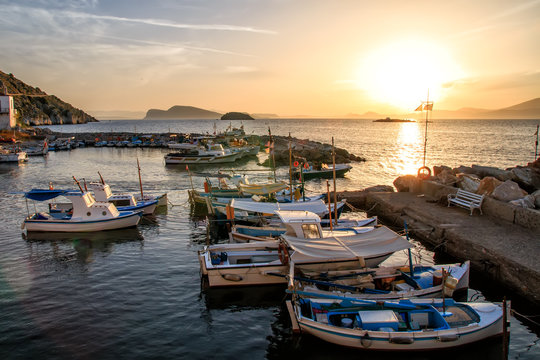 Sea sunset Fishing boats in the pictorial kamini port at Hydra island Greece