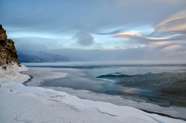 Field of ice hummocks and rock on the frozen Lake Baikal. Sunset
