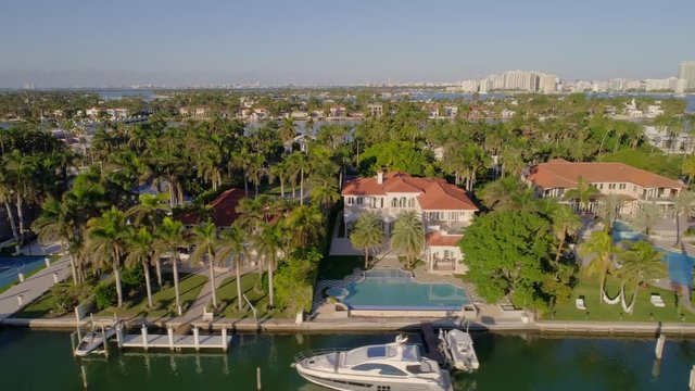Waterfront mansions Miami Beach aerial lateral flight 4k 24p