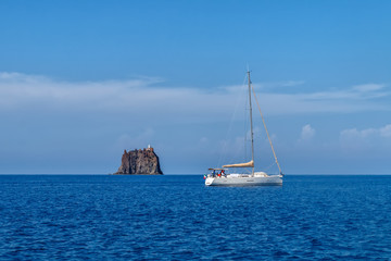 White sailing yacht near Strombolicchio island, Italy