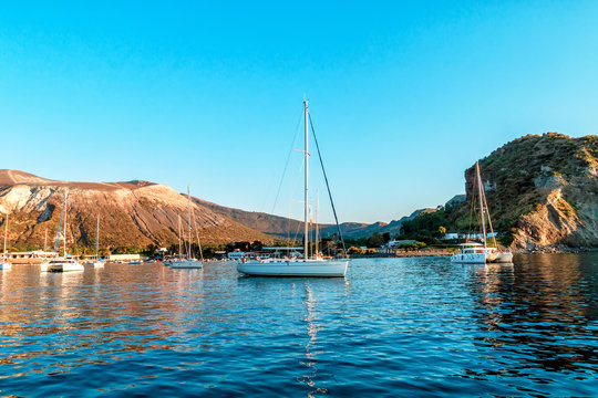 Sailing yachs and catamaran in the Gulf near Vulcano, Aeolian Islands, Tyrrhenian Sea, Sicily, Italy