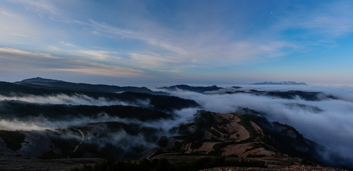 The mountains and the fog dream between them on the horizon