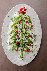 Christmas salad - in form of christmas three, with cucumber, caviar and goat cheese