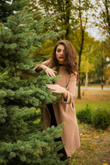 curly-haired girl in a beige coat