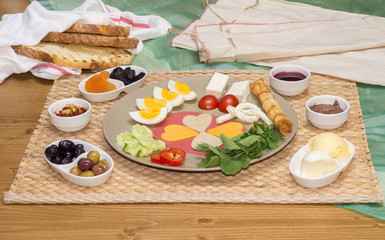 Fototapeta na wymiar Close up of traditional Turkish breakfast served with cheese, salami, boiled egg, tomato, cucumber and toasted bread