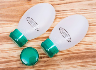 Travel size small plastic with green lids containers 