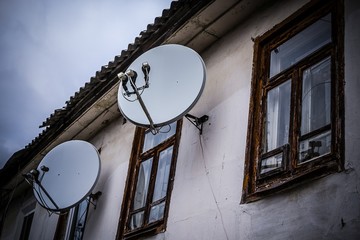 Satellite dishes on the old house