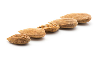 Five shelled almonds in row isolated on white background raw whole brown.