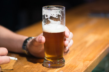 Man holding a beer and cigarette