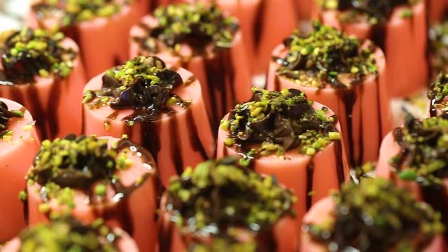 Closeup view of many small jelly cakes served on table for cocktail party or on shelves at store.