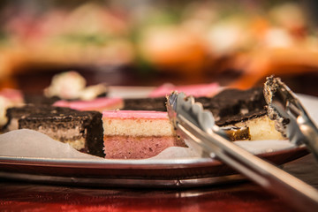 sweet cakes on a plate, on a wooden background