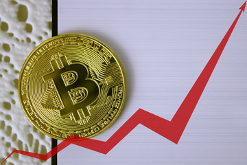 golden coins of bitcoins, the red arrow of the graph is directed upwards