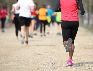Fototapeta premium many people during a race and a girl with black leggings