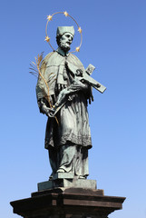 Obraz premium statue of Saint John of Nepomuk who holds the crucifix in his hands