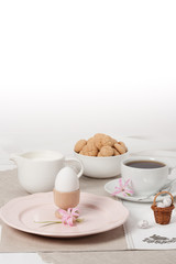 Handmade Natural Linen Napkin With Handmade Cross Stitching. Hyacinth Flowers. Amaretti Biscuits. Boiled Egg. Cup Of Tea