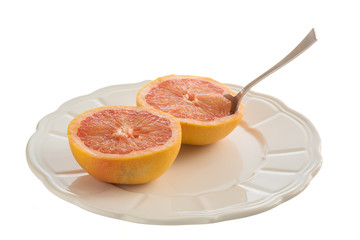 Fototapeta na wymiar Grapefruits on plate with spoon