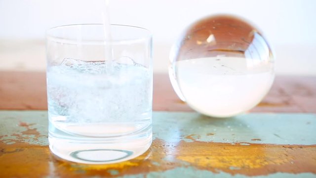 Cinemagraph of glass of water and a glass sphere
