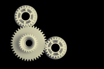 3 plastic gears on black background