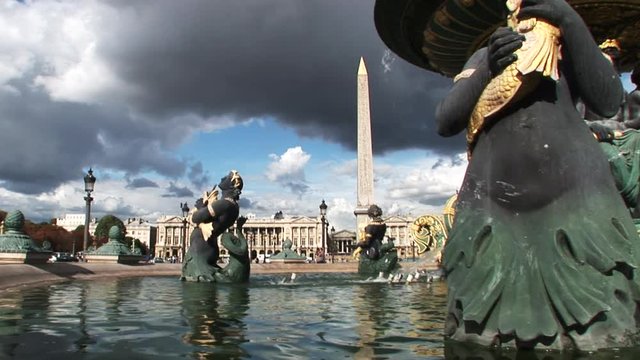 Low angle, dark clouds over Place de la Concorde fountain